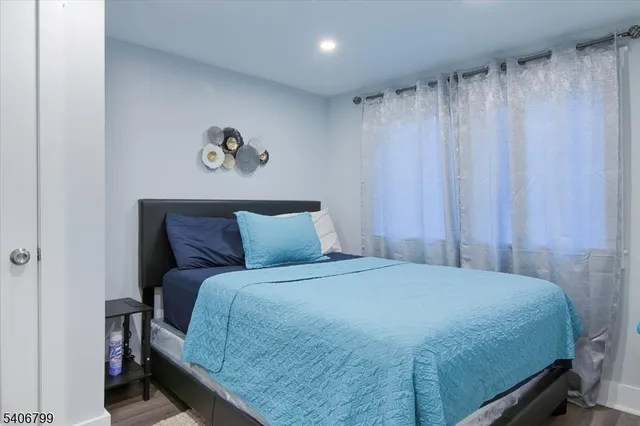 a bedroom with a bed and a curtain