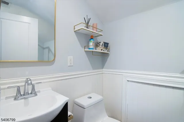 a bathroom with a sink a toilet and mirror