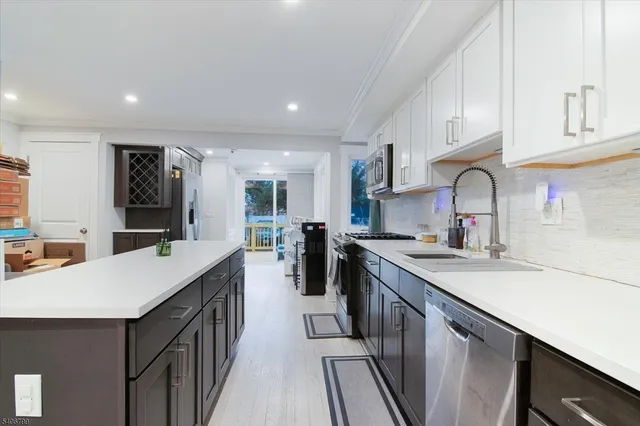 a kitchen with sink stove and cabinets