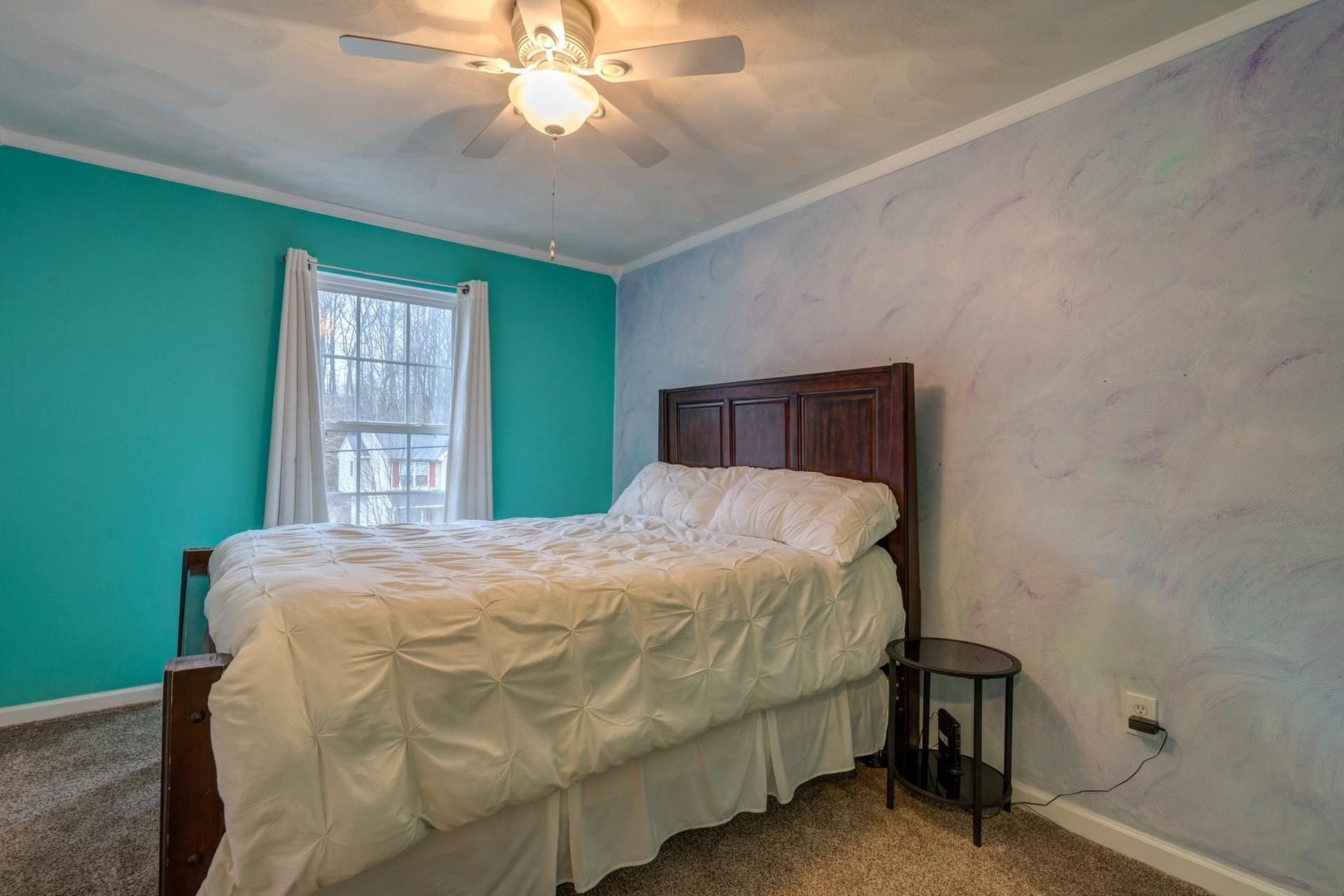 4203 Daugherty Road Salem, VA 24153 - Photo 17 of 35 a bedroom with a bed and a chandelier