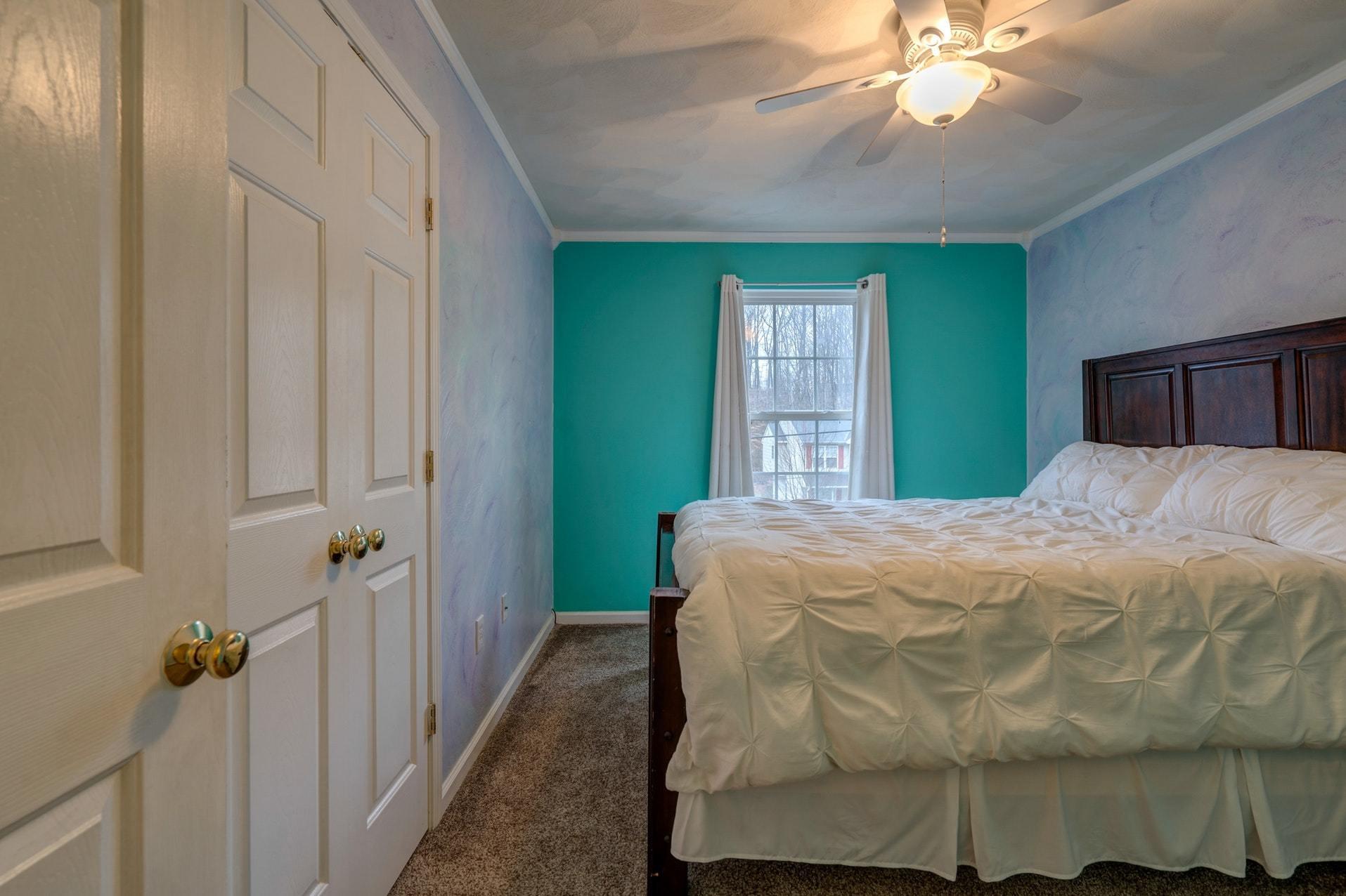 4203 Daugherty Road Salem, VA 24153 - Photo 18 of 35 a bedroom with a bed and a chandelier