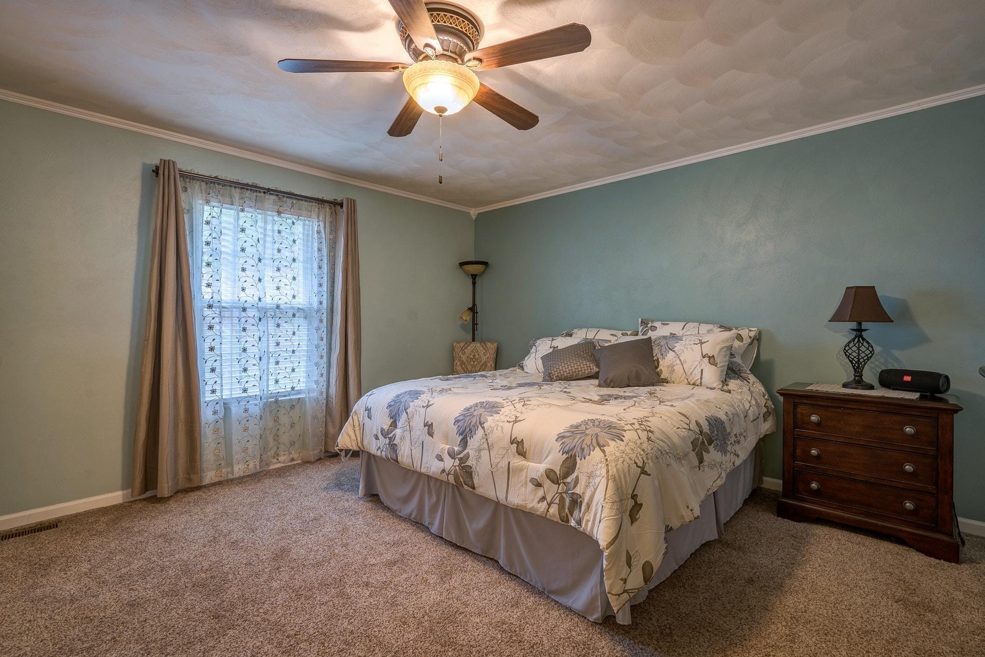 4203 Daugherty Road Salem, VA 24153 - Photo 19 of 35 a spacious bedroom with a bed and a chandelier