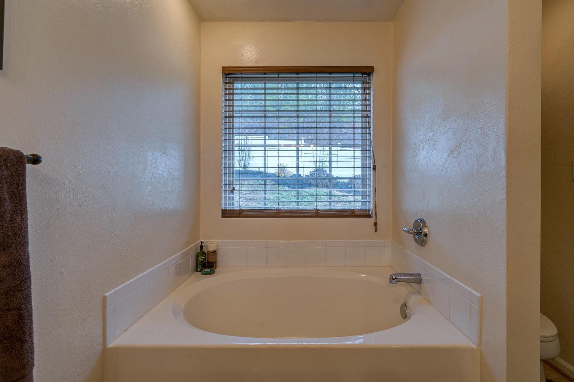 4203 Daugherty Road Salem, VA 24153 - Photo 25 of 35 a white bath tub sitting in a bathroom next to a window