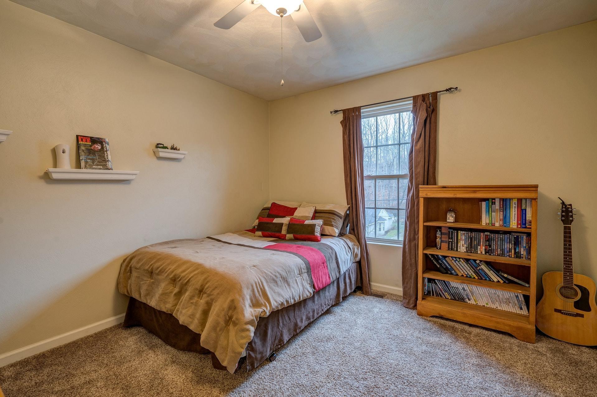 4203 Daugherty Road Salem, VA 24153 - Photo 27 of 35 a bed sitting in a bedroom next to a window