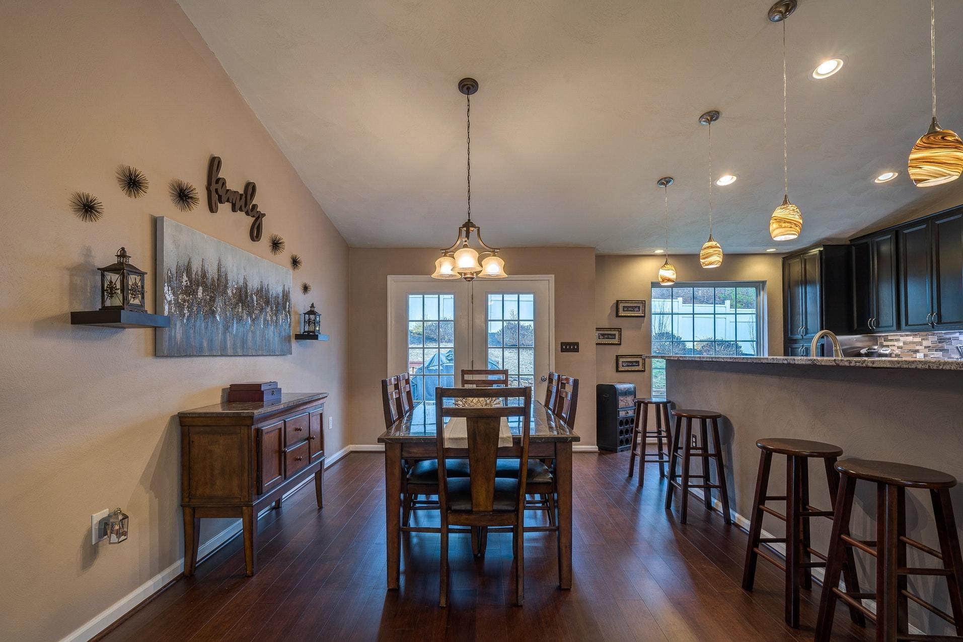 4203 Daugherty Road Salem, VA 24153 - Photo 4 of 35 a dining room with wooden floor a chandelier a wooden table and chairs