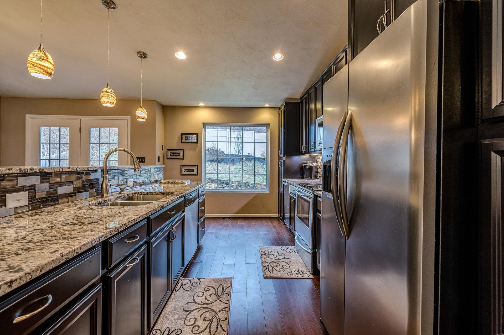 4203 Daugherty Road Salem, VA 24153 - Photo 7 of 35 a kitchen with stainless steel appliances granite countertop a lot of counter space and wooden floor