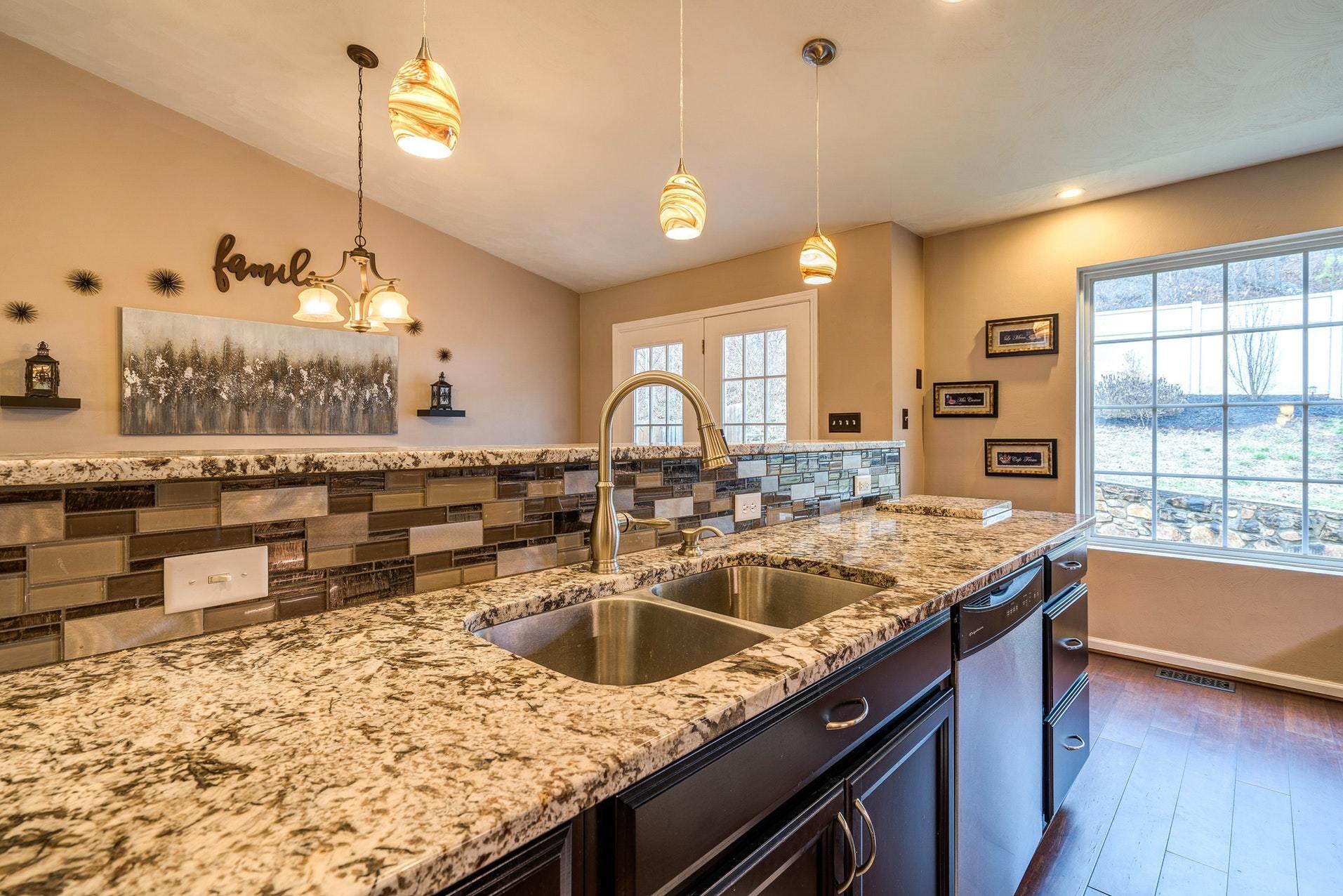 4203 Daugherty Road Salem, VA 24153 - Photo 8 of 35 a kitchen with stainless steel appliances granite countertop a sink a stove and a wooden floors