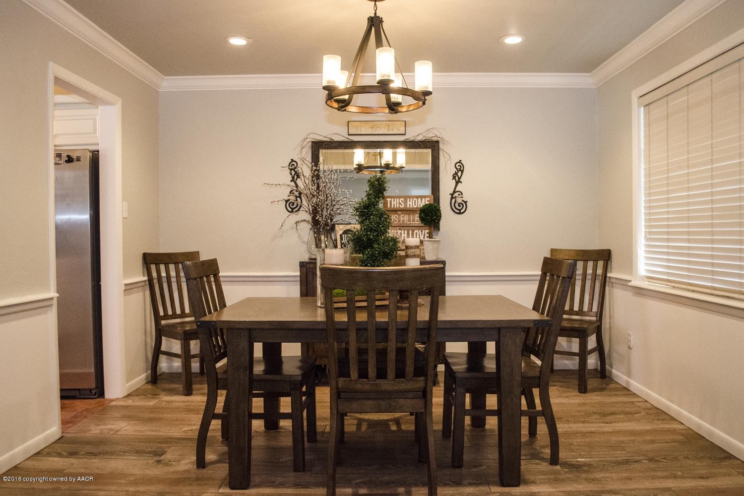 6312 Elmhurst Road Amarillo, TX 79106 - Photo 30 of 85 a view of a dining room with furniture window and wooden floor