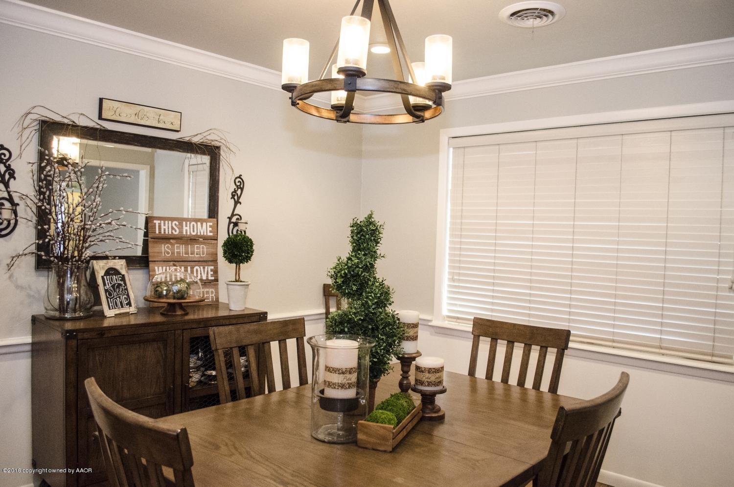 6312 Elmhurst Road Amarillo, TX 79106 - Photo 31 of 85 a view of a dining room with furniture and chandelier