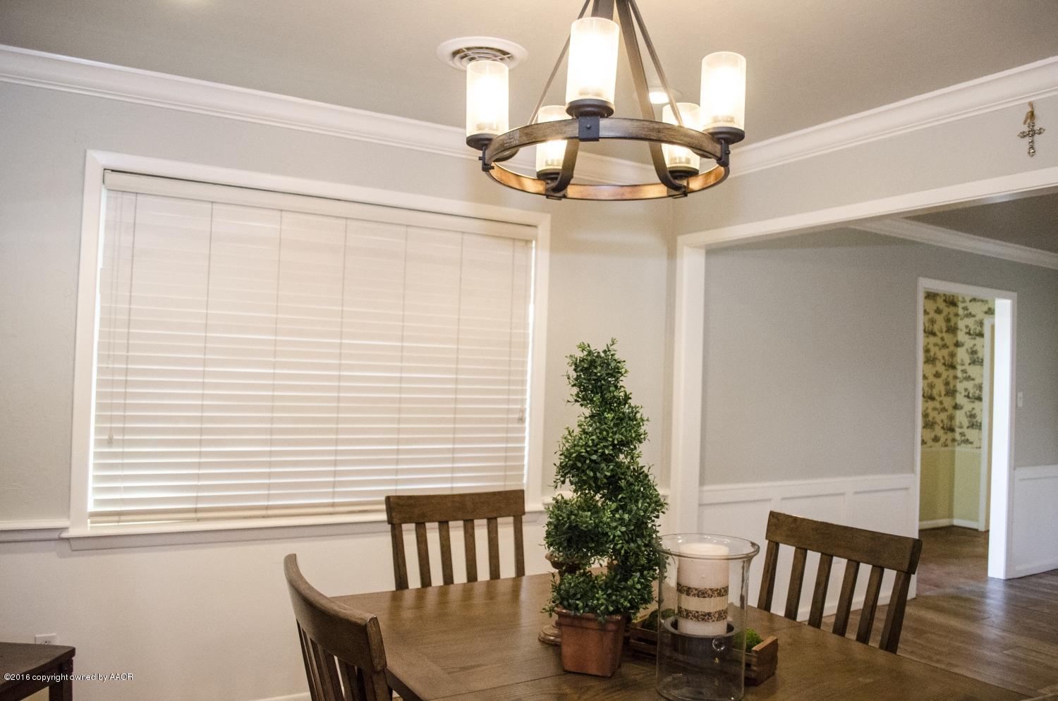 6312 Elmhurst Road Amarillo, TX 79106 - Photo 32 of 85 a view of a dining room with furniture wooden floor and chandelier