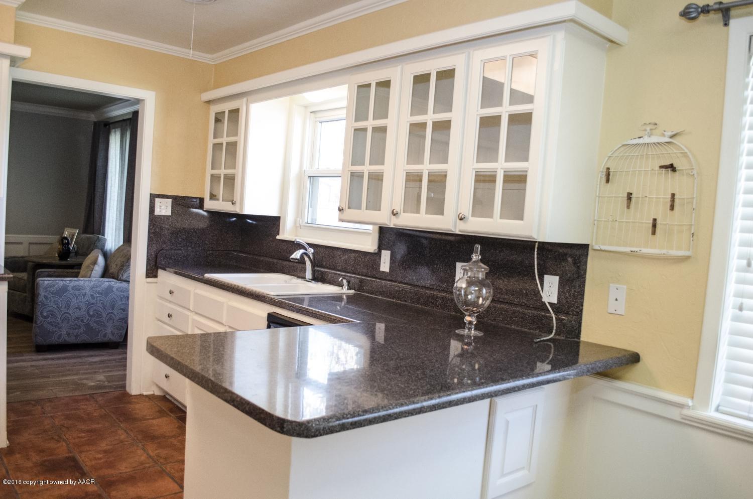 6312 Elmhurst Road Amarillo, TX 79106 - Photo 39 of 85 a kitchen with granite countertop a sink and a granite counter tops