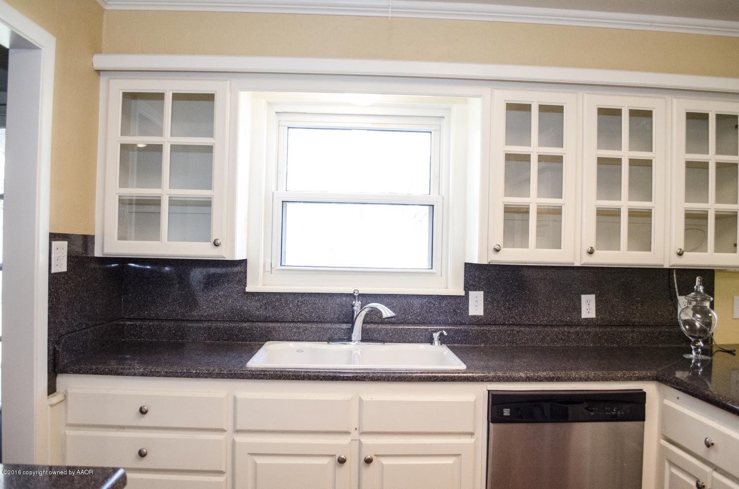 6312 Elmhurst Road Amarillo, TX 79106 - Photo 40 of 85 a kitchen with granite countertop a sink and a stove