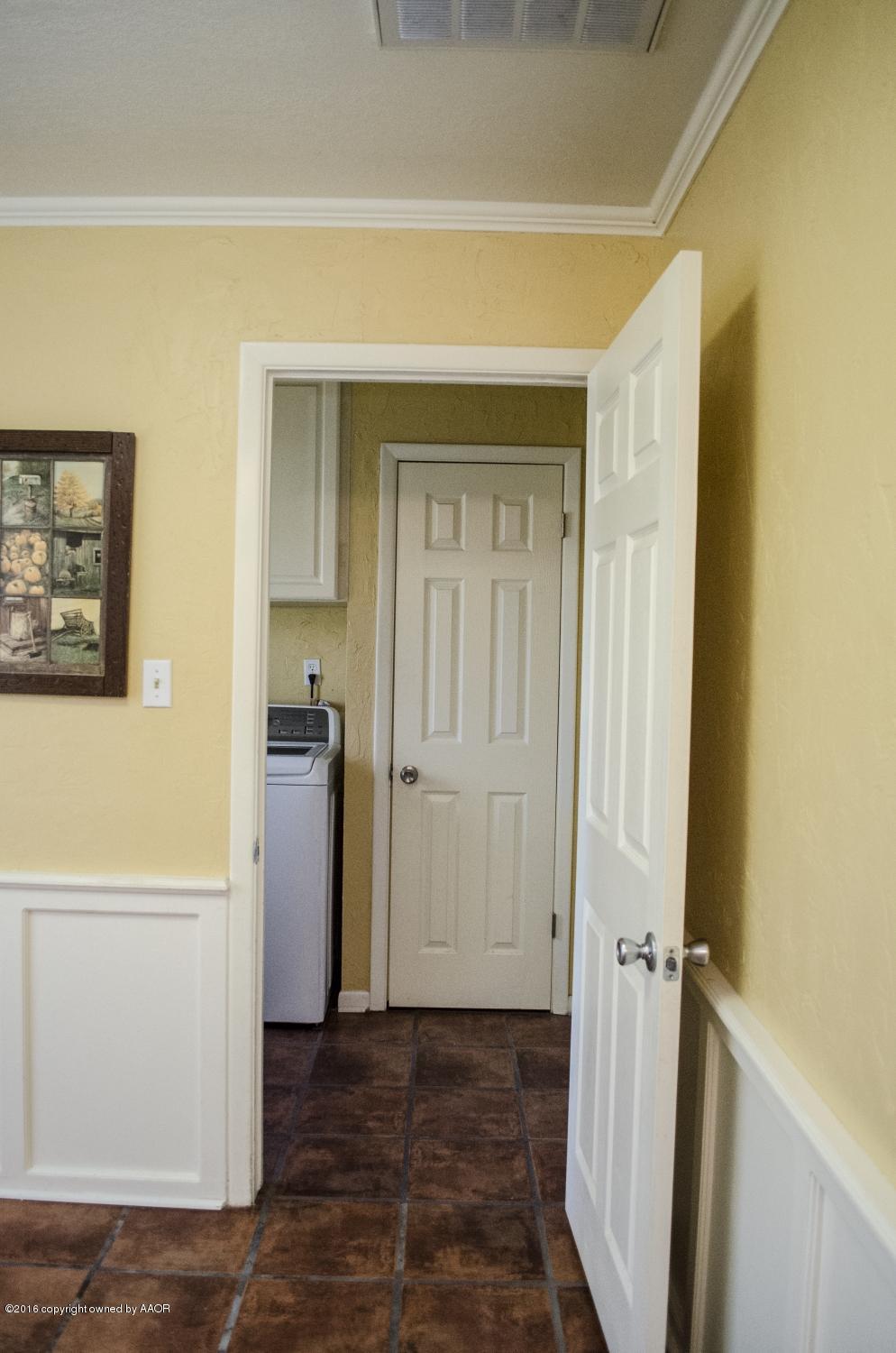6312 Elmhurst Road Amarillo, TX 79106 - Photo 42 of 85 a view of a hallway with wooden floor and cabinet