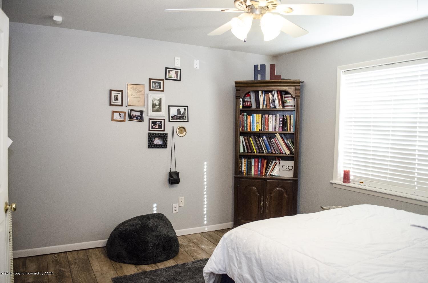 6312 Elmhurst Road Amarillo, TX 79106 - Photo 49 of 85 a bedroom with a bed and a chandelier