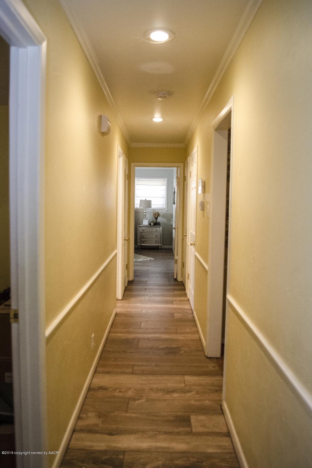6312 Elmhurst Road Amarillo, TX 79106 - Photo 50 of 85 a view of a hallway with wooden floor and a bathroom