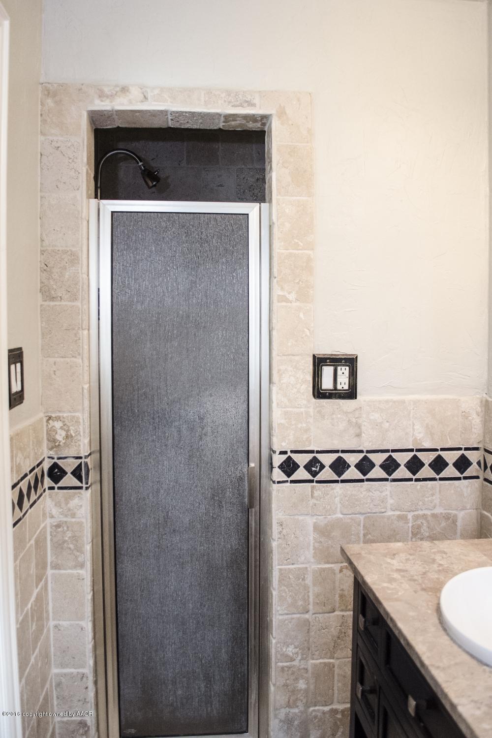 6312 Elmhurst Road Amarillo, TX 79106 - Photo 72 of 85 a bathroom with a granite countertop sink and mirror