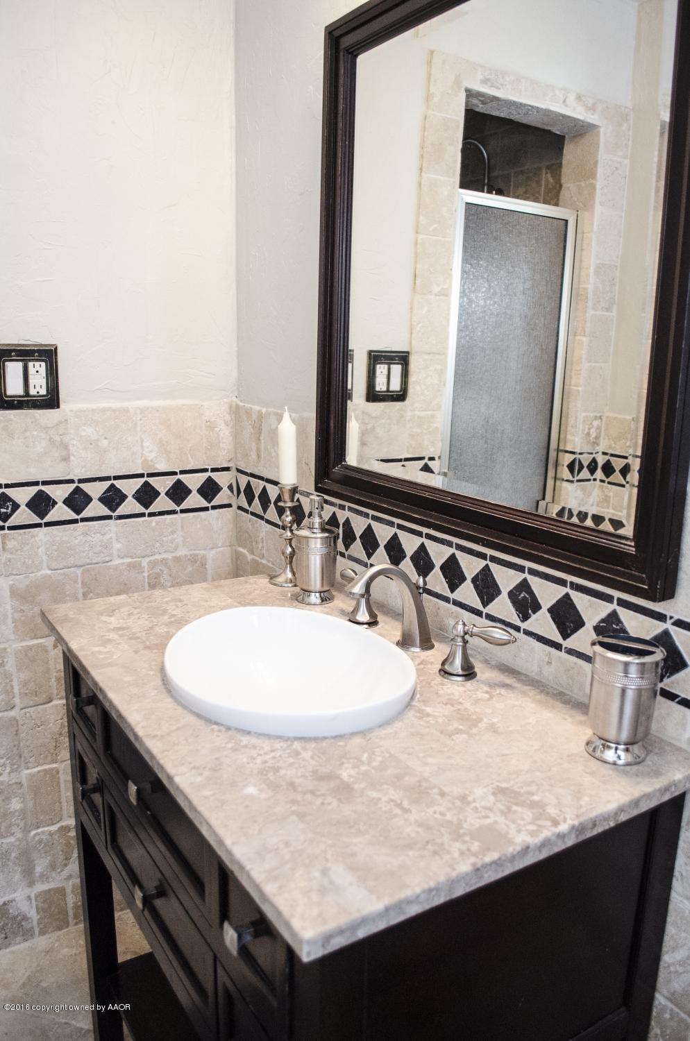 6312 Elmhurst Road Amarillo, TX 79106 - Photo 73 of 85 a bathroom with a granite countertop sink and a mirror