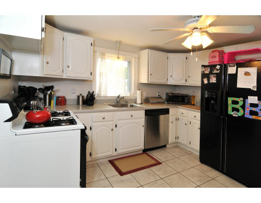 2 Northgate Road Chelmsford, MA 01824 - Photo 4 of 10 a kitchen with a sink dishwasher and white cabinets