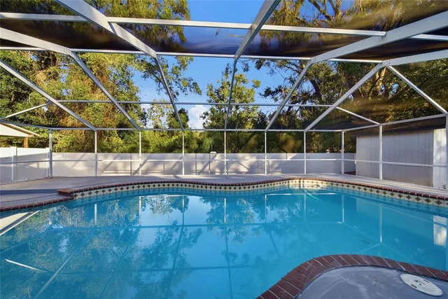 a view of a backyard with a swimming pool