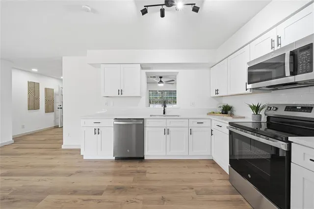 a kitchen with stainless steel appliances granite countertop a stove and a sink