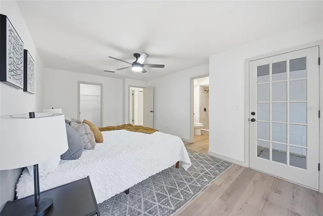a spacious bedroom with a bed and a chandelier