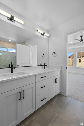 248 West 2920th Street South Logan, UT 84321 - Photo 32 of 47 Double vanity with white cabinetry, black hardware, integrated sinks, and contemporary lighting fixtures