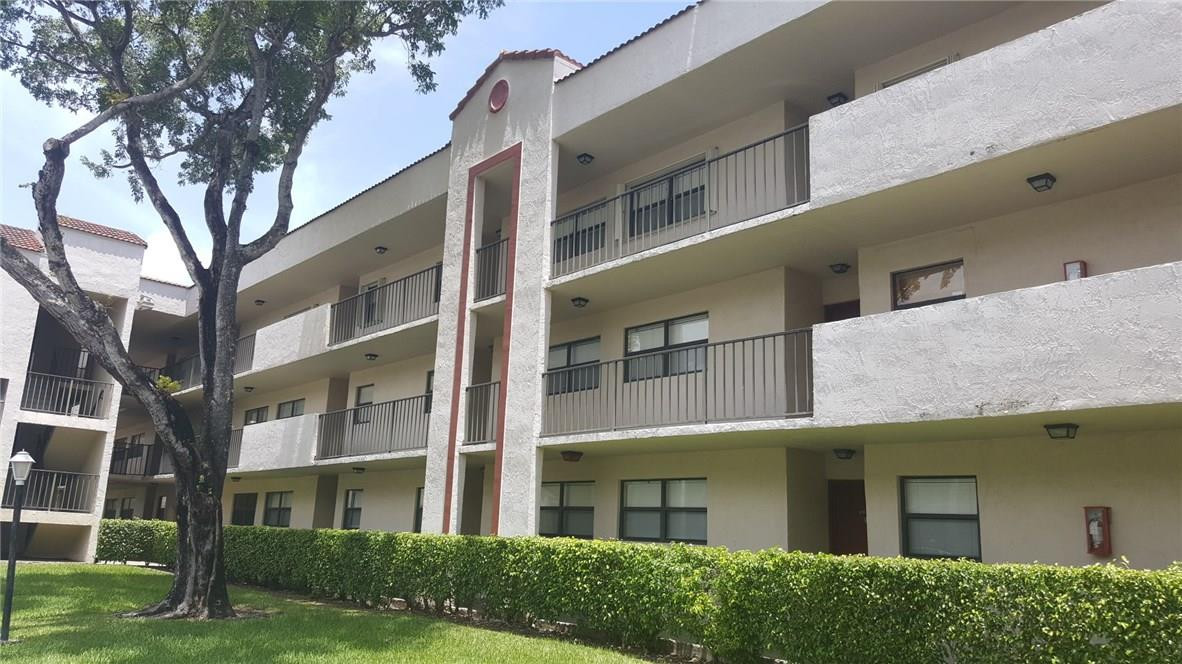 a view of a building with a yard