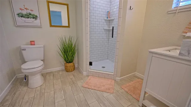 a bathroom with a toilet and a shower