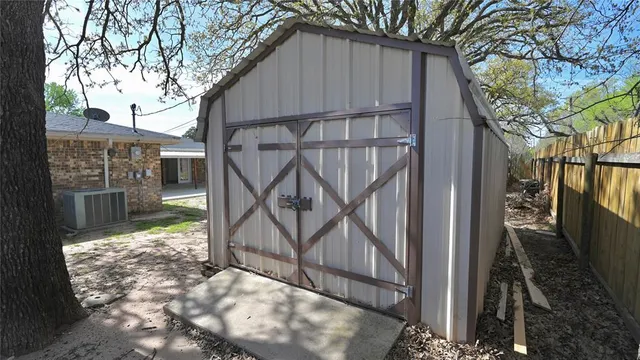 an aerial view of a tennis ground with a yard