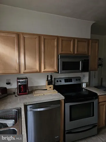 a spacious bedroom with a bed and a window