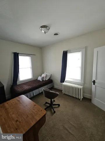 a bathroom with a toilet a sink and a mirror