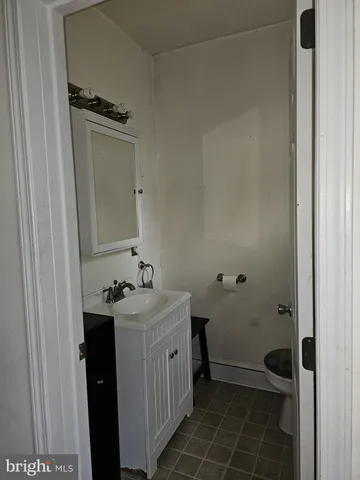 a backyard of a house with barbeque oven table and chairs