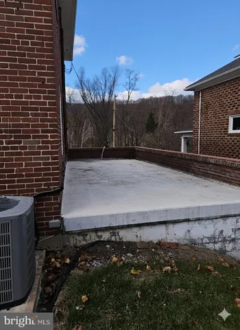 a living room with patio furniture and a fireplace