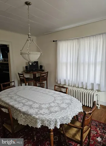 a dining room with furniture a window and a rug
