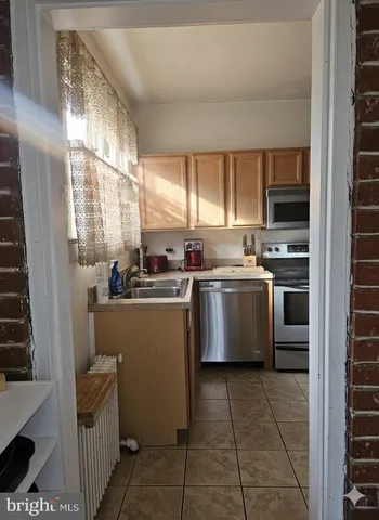 a kitchen with a refrigerator sink and cabinets