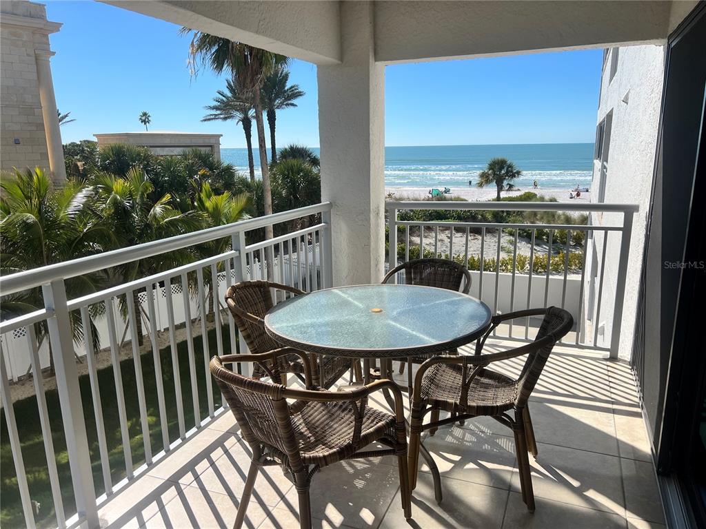 a view of a balcony with a table and chairs