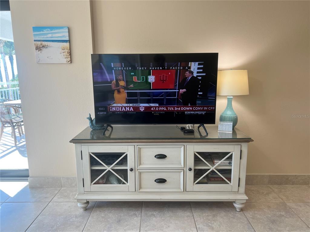 1001 Point Of Rocks Road, Unit 310 Sarasota, FL 34242 - Photo 11 of 35 a living room with furniture and a flat screen tv