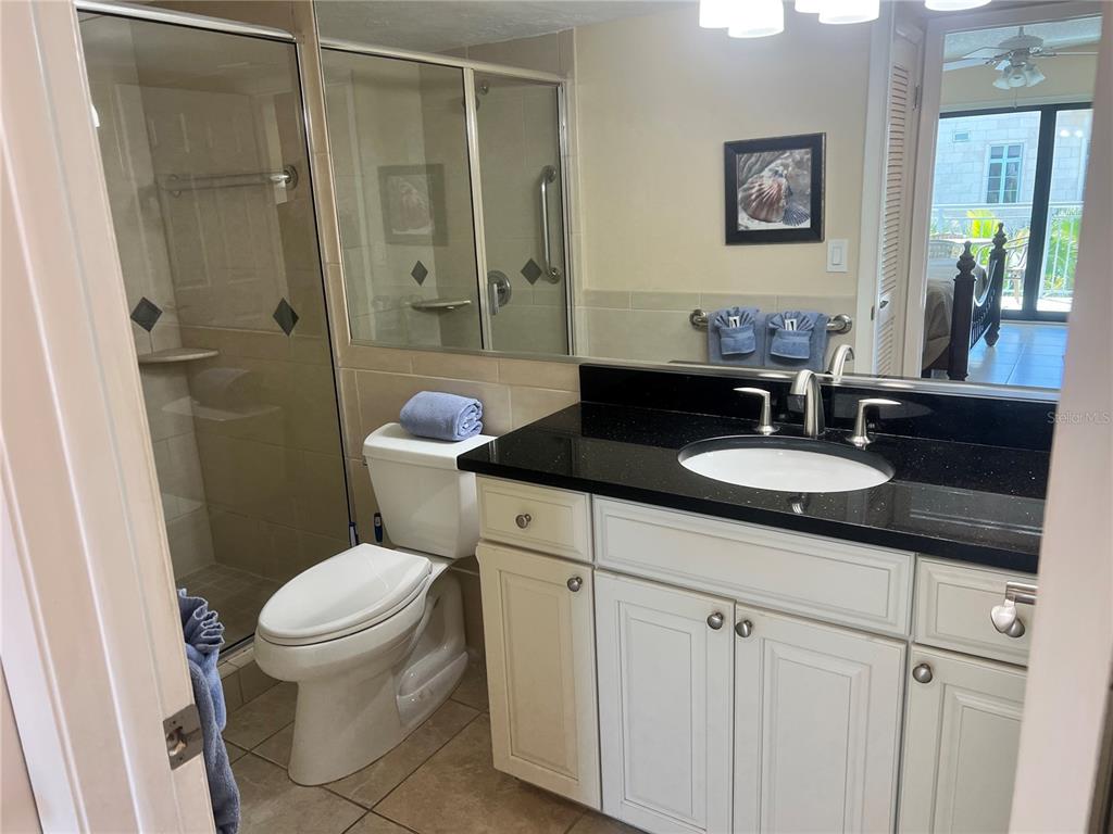 1001 Point Of Rocks Road, Unit 310 Sarasota, FL 34242 - Photo 16 of 35 a bathroom with a sink toilet and shower