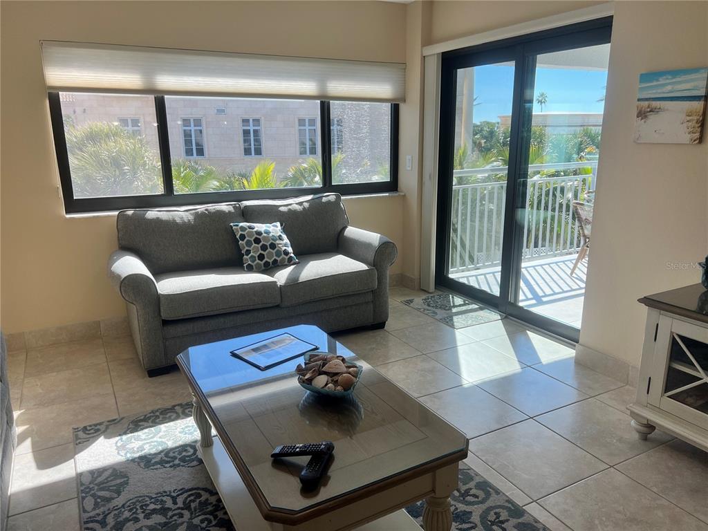 1001 Point Of Rocks Road, Unit 310 Sarasota, FL 34242 - Photo 2 of 35 a living room with furniture and a window