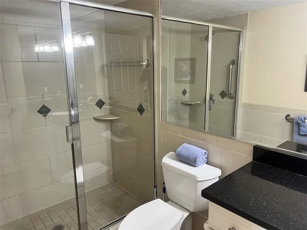 a bathroom with a sink toilet and shower