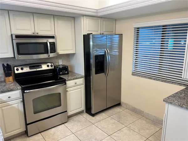 a kitchen with a stove and a refrigerator