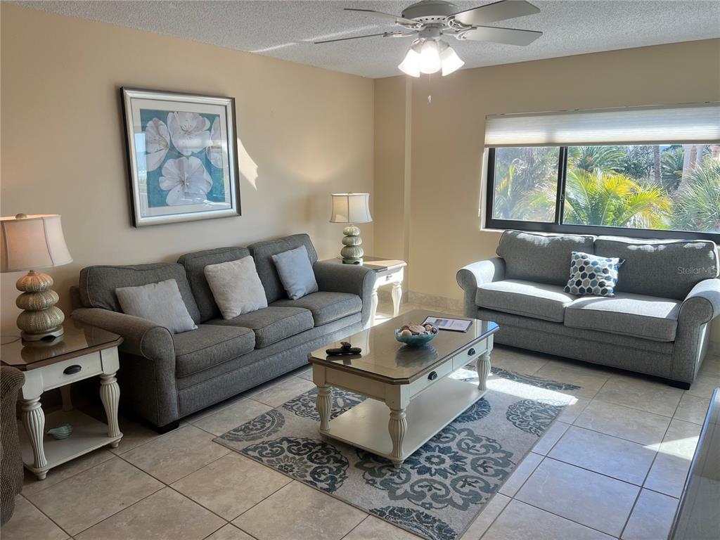 1001 Point Of Rocks Road, Unit 310 Sarasota, FL 34242 - Photo 9 of 35 a living room with furniture and a large window