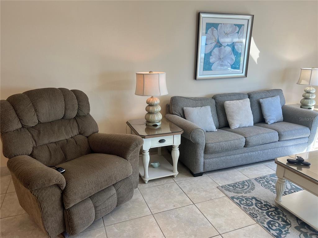 1001 Point Of Rocks Road, Unit 310 Sarasota, FL 34242 - Photo 10 of 35 a living room with furniture and a couch