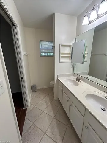 a bathroom with a sink a toilet and mirror