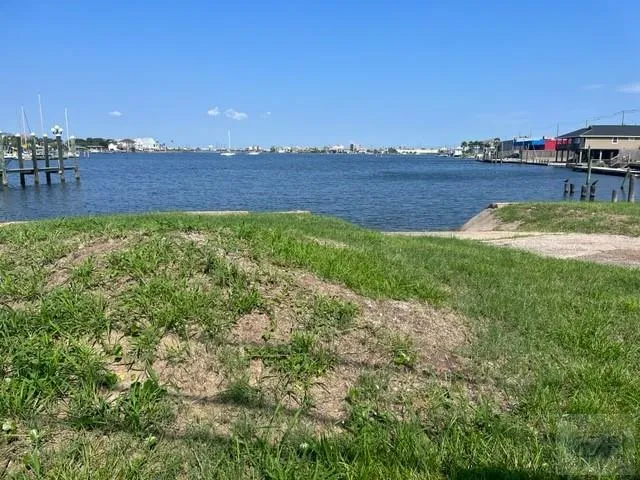 a view of a lake with houses in the back