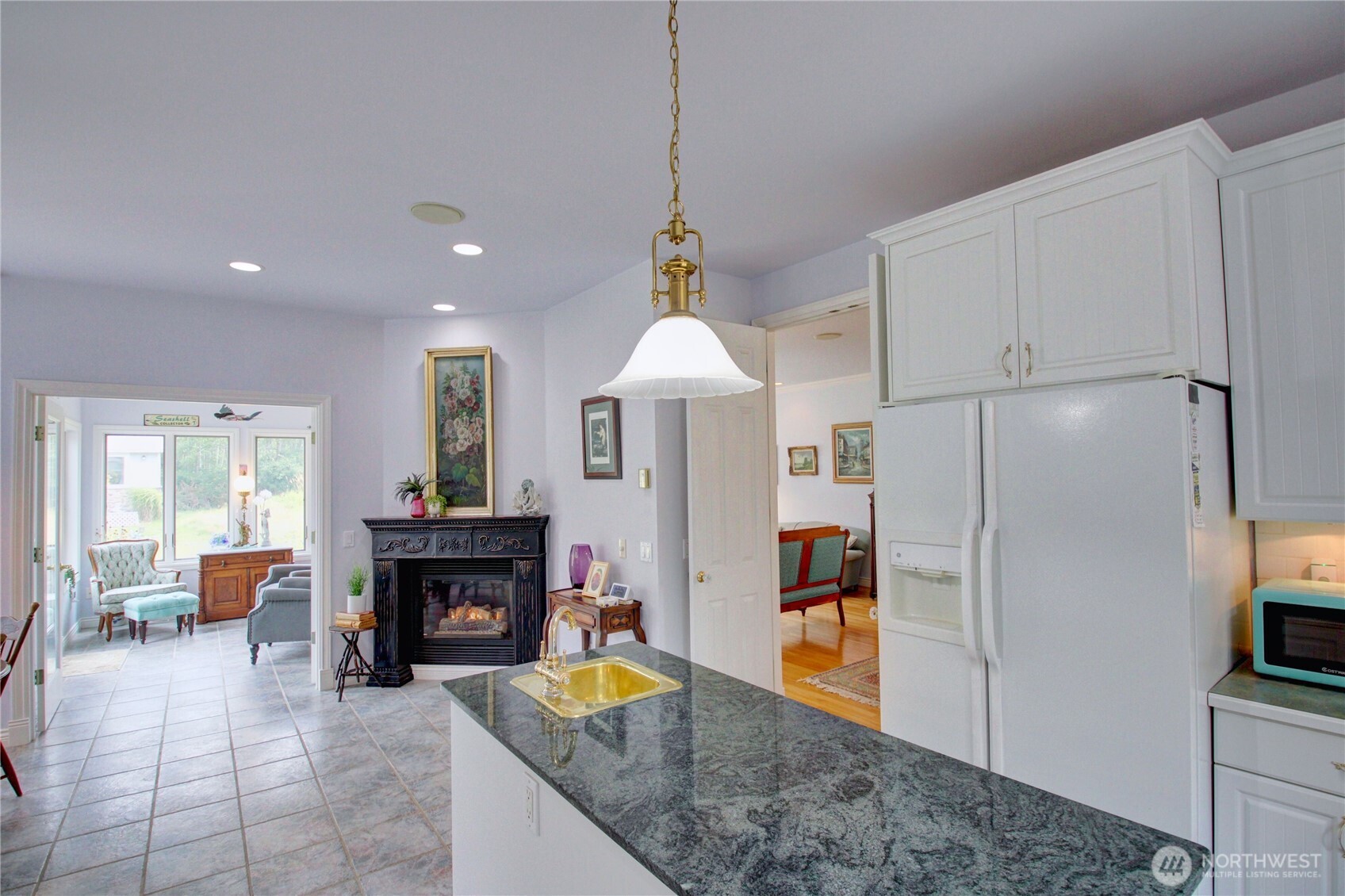 2950 Aldergrove Road Ferndale, WA 98248 - Photo 12 of 39 a kitchen with sink refrigerator and fireplace