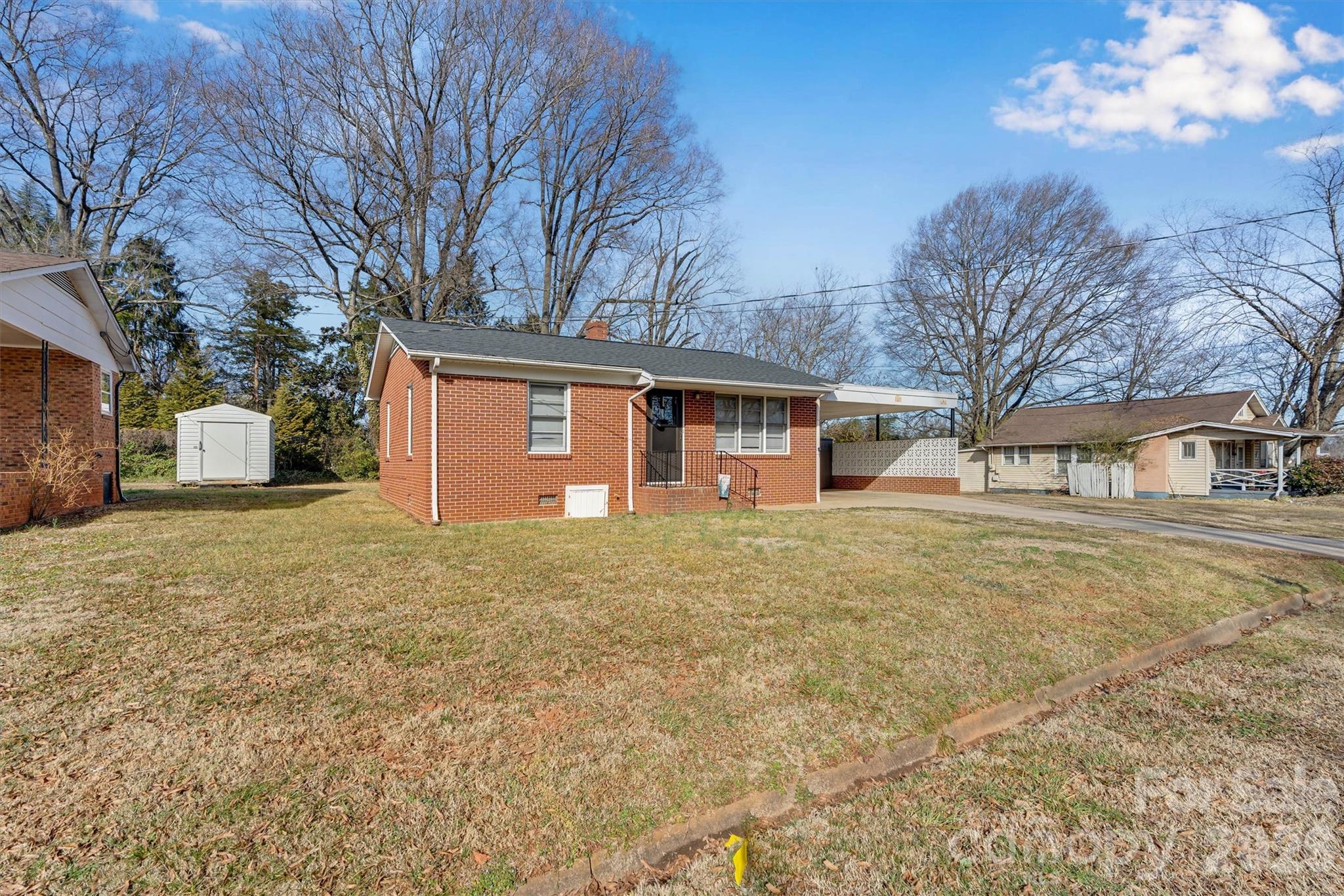 109 9th Street Southeast Conover, NC 28613 - Photo 2 of 9 a front view of a house with a yard and garage