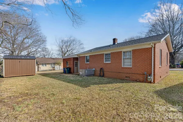 a view of a backyard with large trees