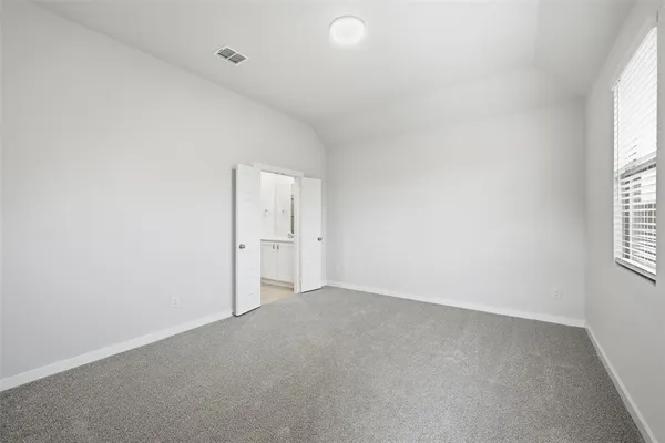 an empty room with windows and entrance