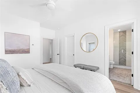 a bedroom with a bed and a mirror